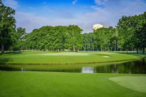 a view of a golf course with a pond at Sheraton Flowood The Refuge Hotel & Conference Center in Flowood