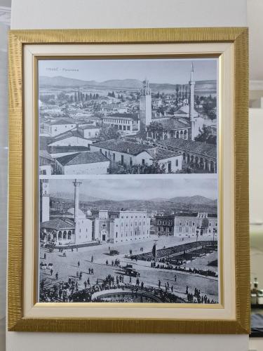 a framed picture of a city with people and buildings at Tirana Center in Tirana