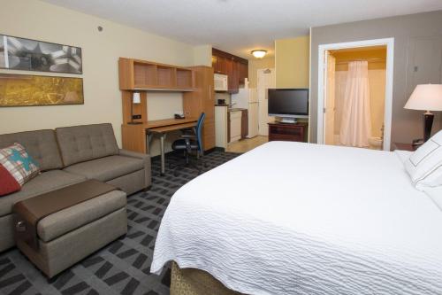 a hotel room with a bed and a couch at TownePlace Suites Pocatello in Pocatello