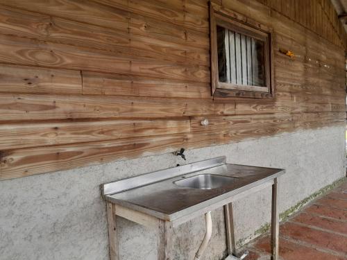 a sink in the side of a wooden wall at Sobradinho in Xangri-lá