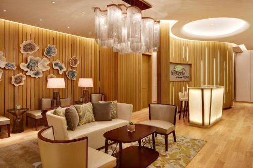 a living room with a couch and chairs and a table at The Westin Jakarta in Jakarta
