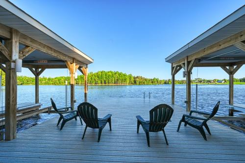 a group of chairs sitting on a dock next to the water at Dream Lake Castle in Mineral
