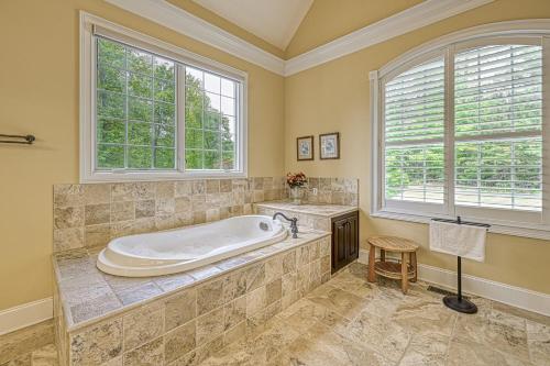 a large bathroom with a tub and windows at Dream Lake Castle in Mineral