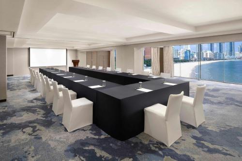 a conference room with a long table and white chairs at The Westin Josun Busan in Busan