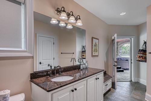 a bathroom with a sink and a large mirror at Dream Lake Castle in Mineral