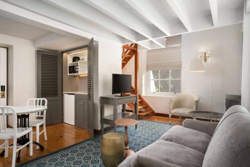 a living room with a couch and a table at Protea Hotel by Marriott Cape Town Mowbray in Cape Town