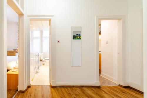a room with a white wall and a door at Newly Furnished Flat 4 Minutes Walk To Metro in Glasgow