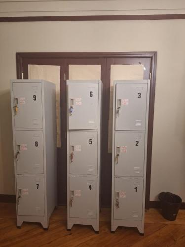 three white lockers are sitting in a room at Easy Host Porto in Porto