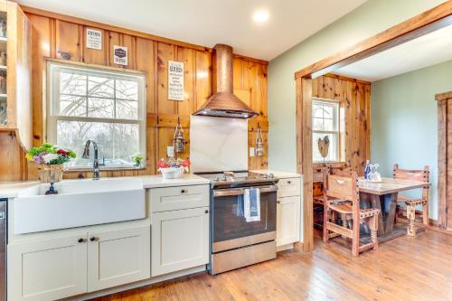 a kitchen with wooden walls and wooden flooring at Grill and Fire Pit New Market Getaway on 3-Acres! in New Market
