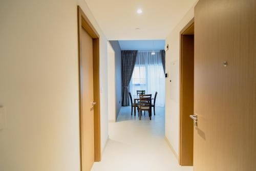 a hallway with a table and a dining room at Luxurious 3 bedrooms Apartment Maryam Island by Stay Bnb in Sharjah