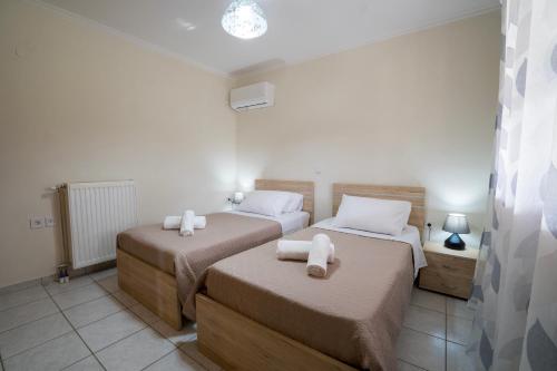 a bedroom with two beds with towels on them at Almond's Room in Mirina