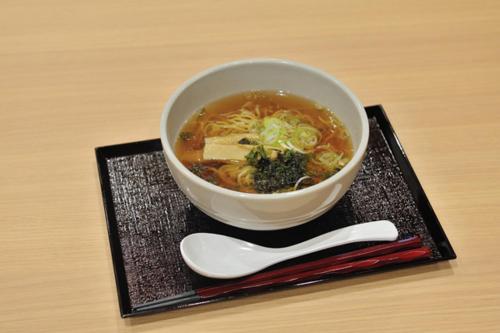 a bowl of soup on a plate with a spoon at Onyado Nono Toyama Natural Hot Spring in Toyama