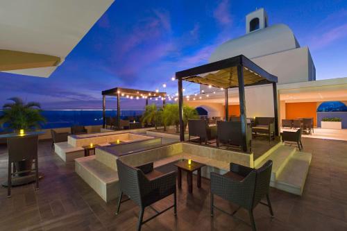 an outdoor patio with tables and chairs at night at The Westin Playa Bonita Panama in Playa Bonita Village