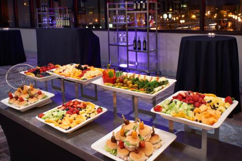 a buffet of fruits and vegetables on a table at Marriott East Lansing at University Place in Lansing