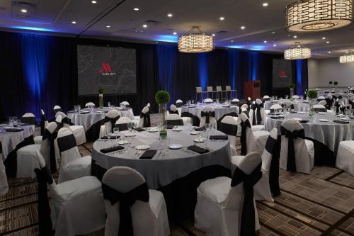 a banquet hall with white tables and chairs at Marriott East Lansing at University Place in Lansing