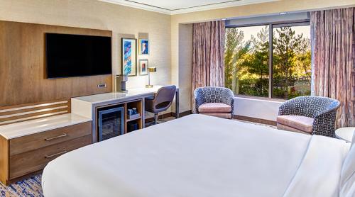 a hotel room with a bed and a television at Mystic Lake Casino Hotel in Prior Lake