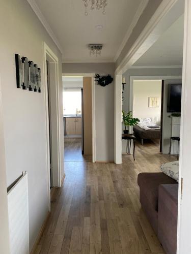 a living room with a couch and a dining room at Country Home in Selfoss
