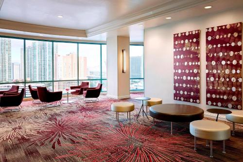 a lobby with chairs and tables and a large window at Las Vegas Marriott in Las Vegas