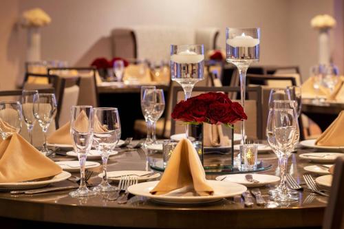 a table with plates and glasses and a flower on it at Las Vegas Marriott in Las Vegas