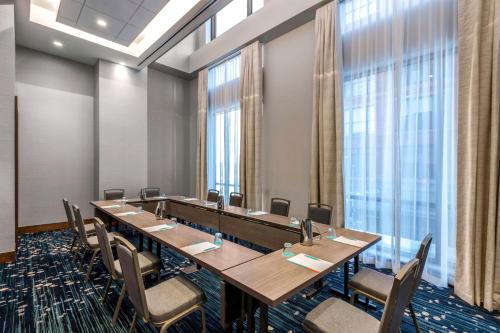 a conference room with a long table and chairs at Le Meridien Denver Downtown in Denver