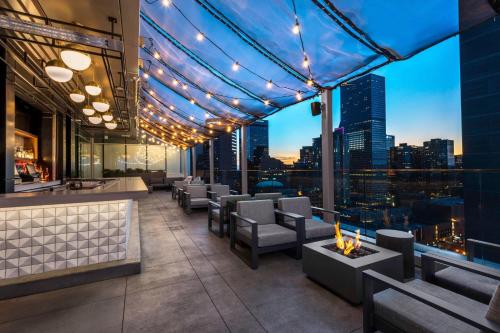 a rooftop bar with a view of the city at Le Meridien Denver Downtown in Denver