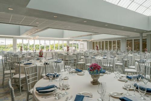 a banquet hall with white tables and chairs at TownePlace Suites by Marriott Chicago Schaumburg in Schaumburg