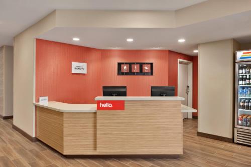 an office with a kico counter and a refrigerator at TownePlace Suites Cedar Rapids Marion in Cedar Rapids