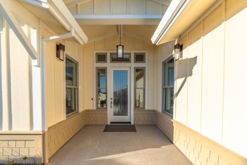 a front porch of a home with a white door at High Tide Haven - Hot Tub Harbor Views in Bodega Bay
