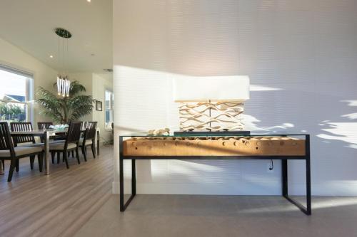 a table with a lamp on it in a dining room at High Tide Haven - Hot Tub Harbor Views in Bodega Bay