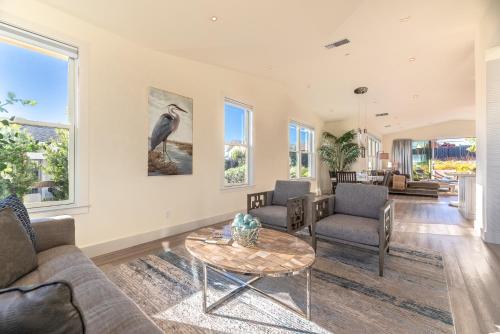 a living room with a couch and a table at High Tide Haven - Hot Tub Harbor Views in Bodega Bay