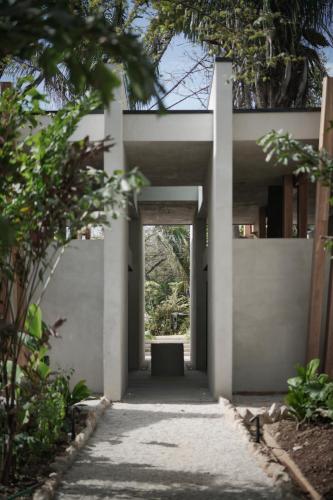a white house with a door in a yard at Esh Hotel & Spa in Nosara