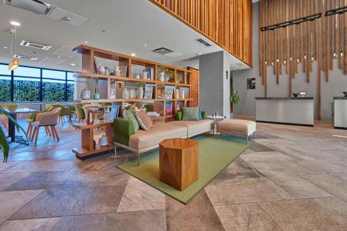 a living room with a couch and a table at City Express Plus by Marriott Tampico in Tampico