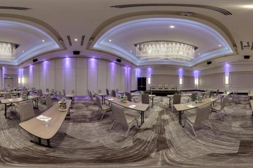 a banquet hall with tables and chairs and a chandelier at TownePlace Suites by Marriott Oshawa in Oshawa