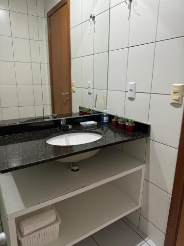 a bathroom with a sink and a mirror at Casa em Condomínio - Salinópolis in Salinópolis