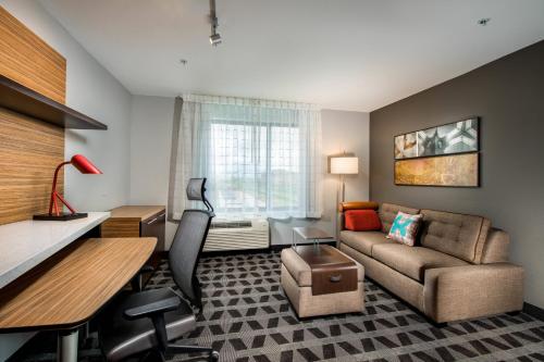 a living room with a couch and a desk at TownePlace Suites by Marriott Waco South in Waco