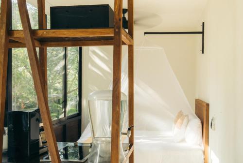 a room with a ladder and a glass table at Casa Selva Sayulita in Sayulita