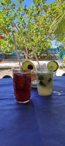 three cocktails on a table with a blue table cloth at Villa Karina B&B in Itaparica Town