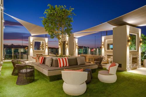 a living room with a couch and chairs on the grass at Protea Hotel Fire & Ice! by Marriott Pretoria Menlyn in Pretoria