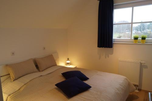 a bedroom with a bed with two pillows on it at Premium Apartments in Wendisch Rietz