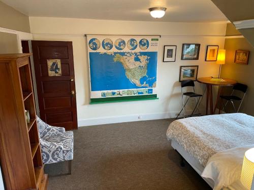 a bedroom with a map of the world on the wall at Portland International Guesthouse in Portland