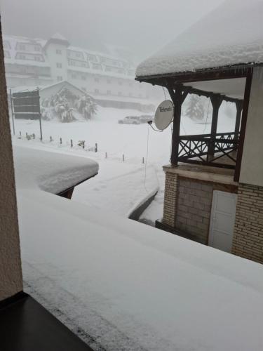 a snow covered street with a snow covered slope at TomaR-Gondola in Kopaonik