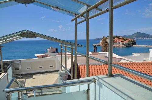 a view of the ocean from the balcony of a house at Apartments Secret Garden in Sveti Stefan