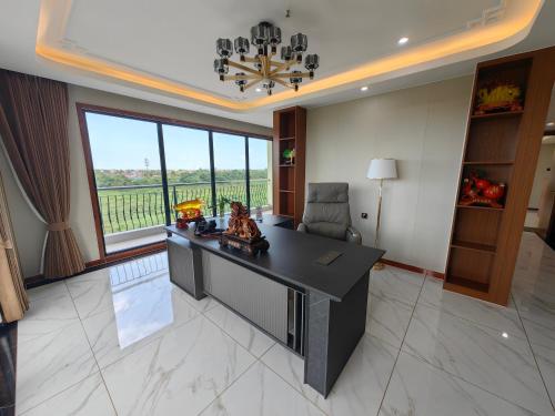a living room with a desk and a large window at Royal International Hotel & Mall in Georgetown