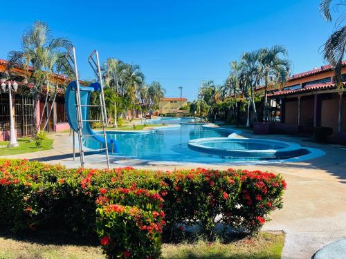 a swimming pool with a slide in a resort at Cómodo town-house con piscina in El Marite
