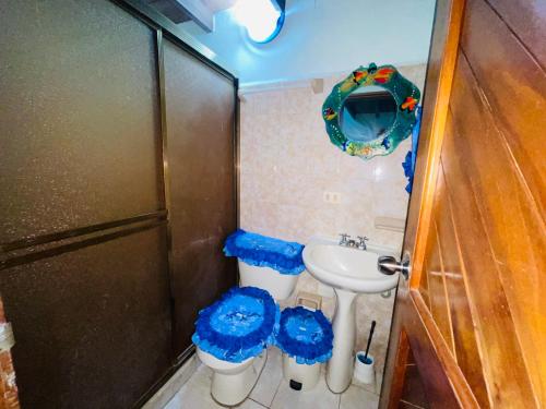 a small bathroom with a sink and a toilet at Cómodo town-house con piscina in El Marite