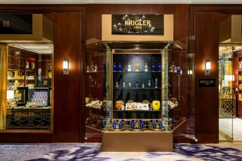 a display case in a store with bottles of alcohol at The Ritz-Carlton, Dallas in Dallas