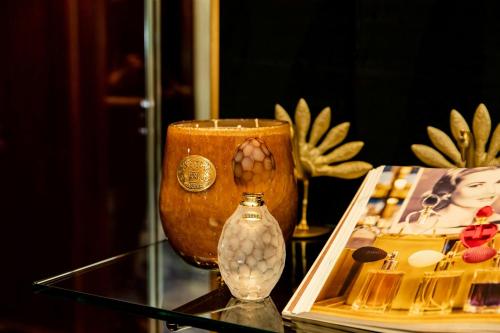 a glass table with a vase and a vase with a candle at The Ritz-Carlton, Dallas in Dallas