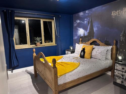 a bedroom with a bed with a castle mural on the wall at Hogwarts apartment in Abbots Langley