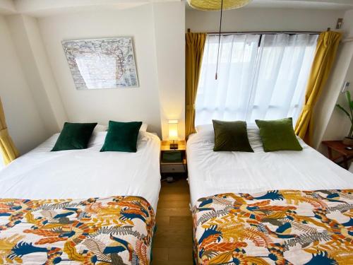 a bedroom with two beds and a window at 1min walk to sta, Many food, Near Shibuya and HND in Tokyo