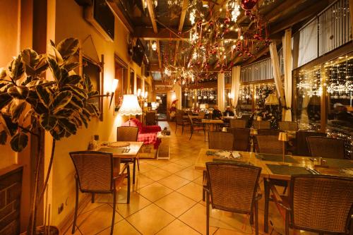 a restaurant with tables and chairs in a room at Hotel Restaurant Freihof in Oberharmersbach